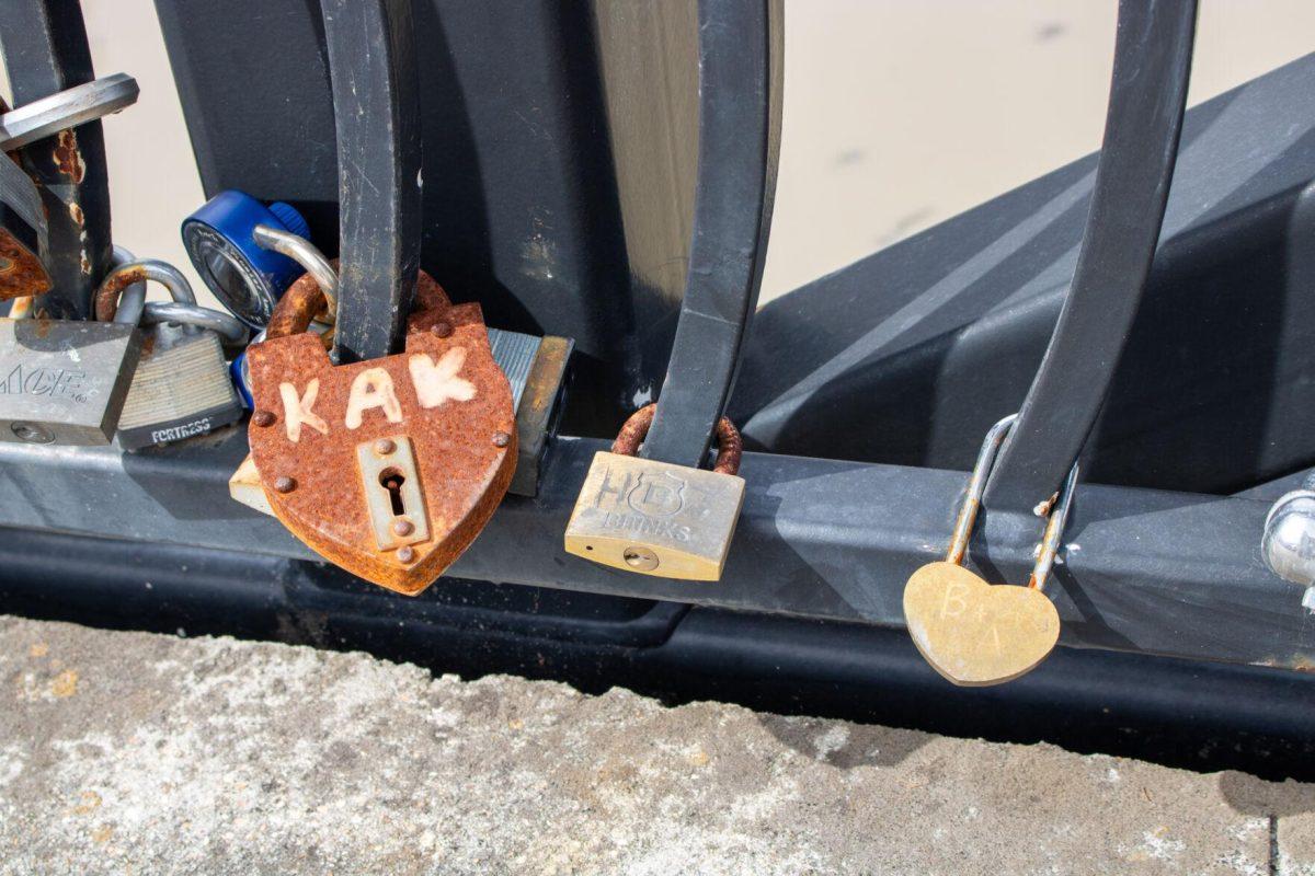 A big and rusted lock reads "KAK" representing someone's intials on Thursday, Feb. 8, 2024, at Milford Wampold Memorial Park on Standford Ave. in Baton Rouge, La.