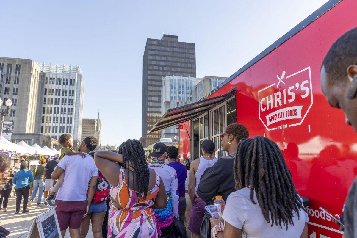 Event-goers stand in life for "Chris's Specialty Foods" Sunday, Feb. 25, 2024, during the second annual 225Fest 2024 at 660 N. Fourth St. in Baton Rouge, La.