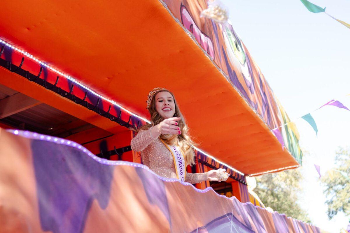 LSU Homecoming Queen Juliette LeRay tosses beads from a float Tuesday, Feb. 6, 2024, during Campus Life's Mardi Gras Mambo event on Tower Drive.