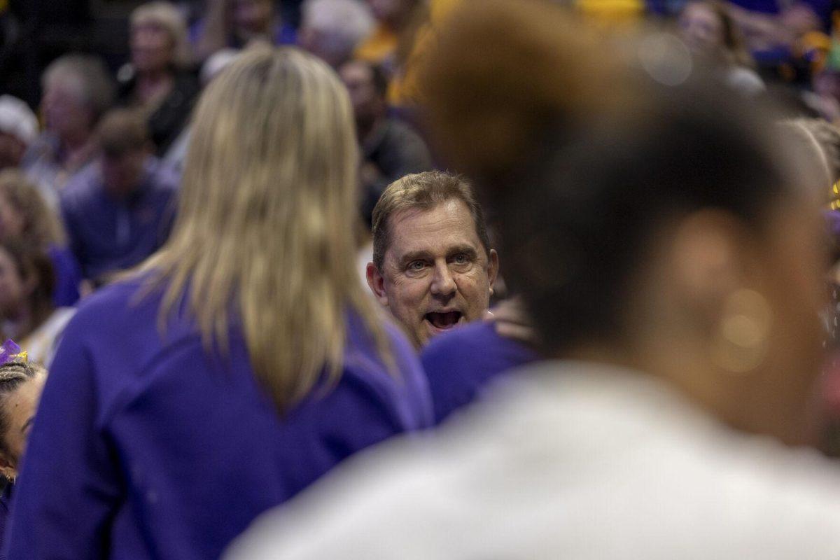 LSU gymnastics head coach Jay Clark speaks to his team Friday, Feb. 16, 2024, during LSU's win 198.300-197.10 against Auburn in the Pete Maravich Assembly Center.