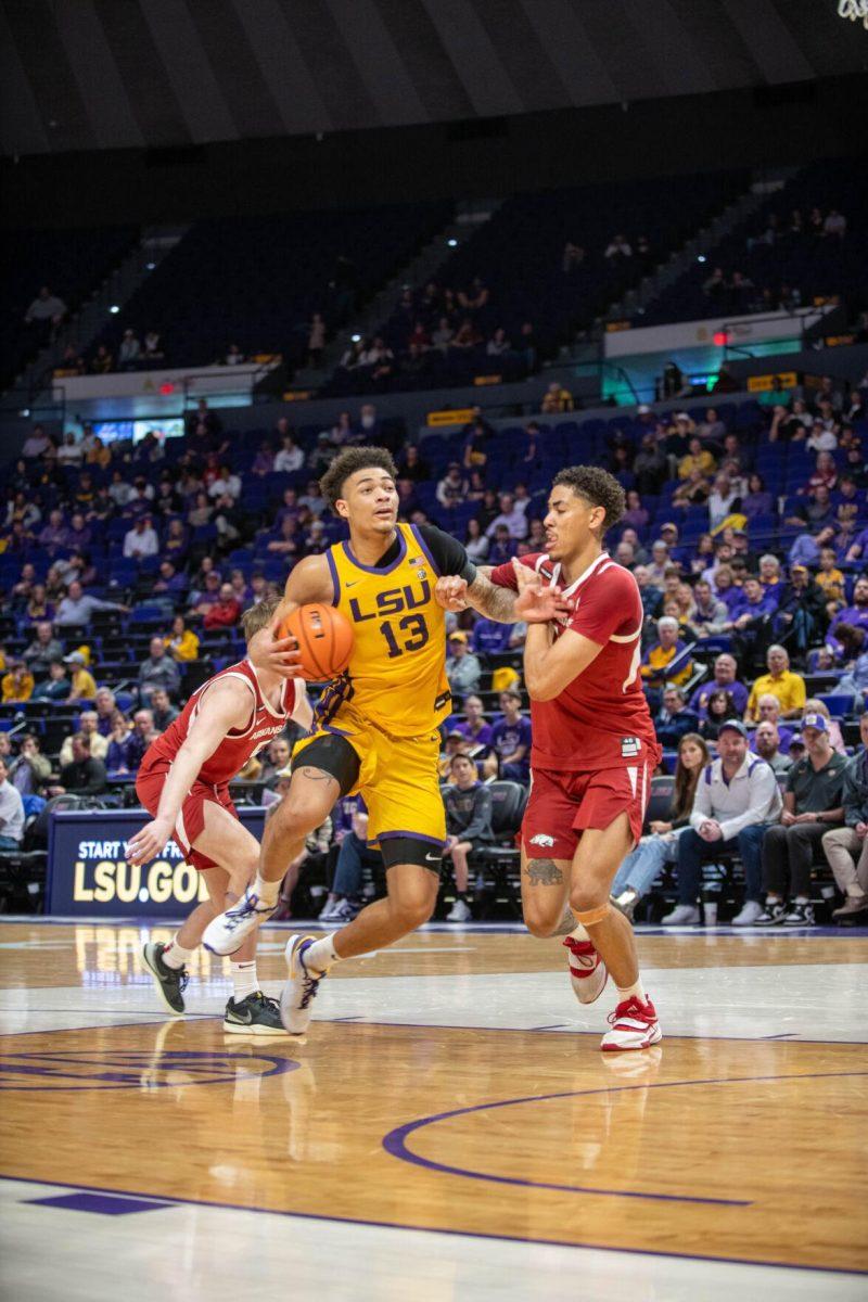 LSU men's basketball sophomore forward Jalen Reed (13) guards the ball on Saturday, Feb. 3, 2024, during LSU's 94-74 win against Arkansas in the Pete Maravich Assembly Center in Baton Rouge, La.