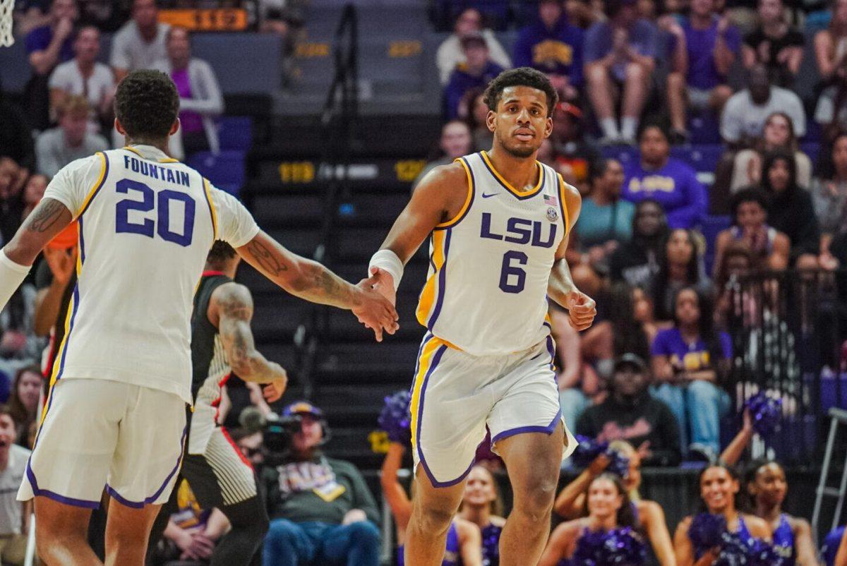 LSU men&#8217;s basketball graduate student guard Jordan Wright (6) high fives senior forward Derek Fountain (20) after scoring Tuesday, Feb. 27, 2024, during LSU&#8217;s game against Georgia in the Pete Maravich Assembly Center in Baton Rouge, La.