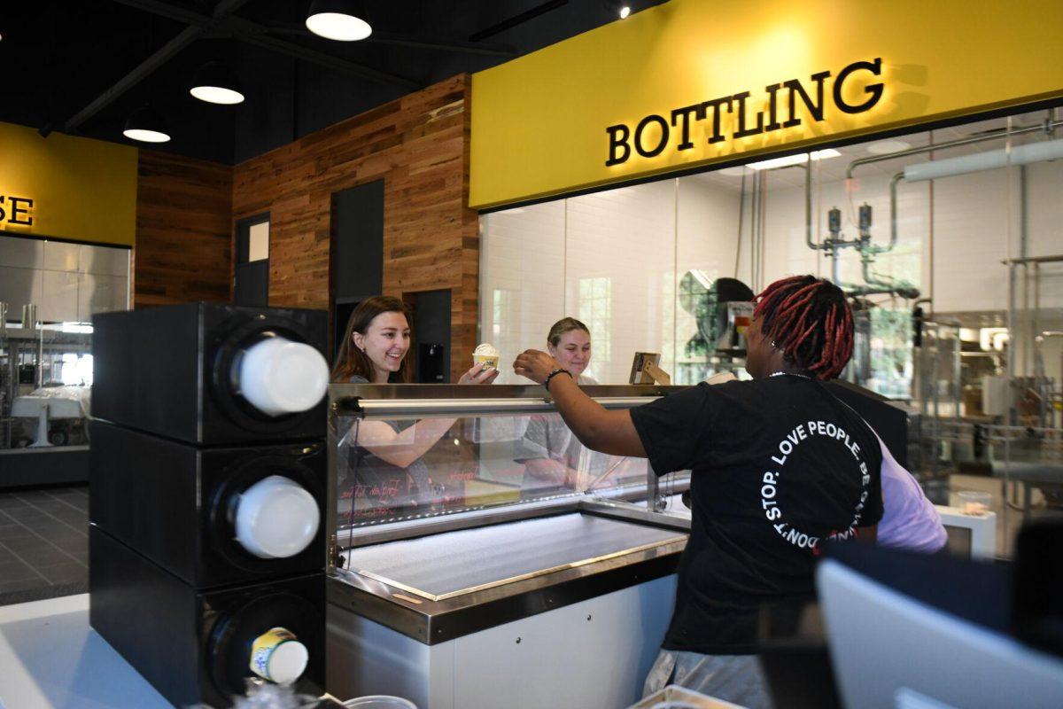 LSU psychology sophomore Shanice Snell serves a customer at the new Dairy Store location Tuesday, Feb. 20, 2024, on S. Campus Dr. on LSU&#8217;s campus in Baton Rouge, La.