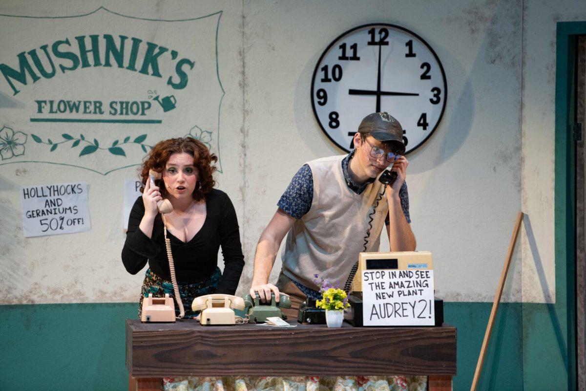 LSU theatre technology and design freshman Kamryn Hecker and psychology junior Thomas Becnel answer phones Thursday, Feb. 1, 2024, during LSU Musical Theatre Club's performance of "Little Shop of Horrors" at the Reilly Theatre in Baton Rouge, La.