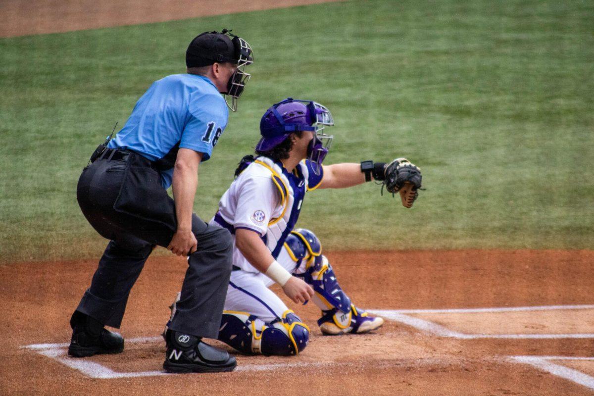 LSU baseball graduate student catcher Alex Milazzo (7) prepares to catch the pitch during LSU's 11-8 win against VMI on Friday, Feb. 16, 2024, at Alex Box Stadium in Baton Rouge, La.