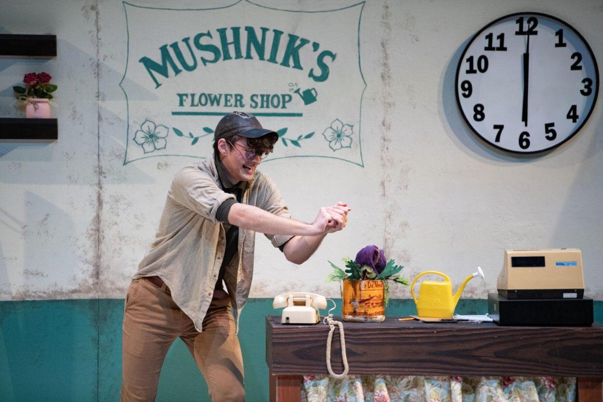 LSU psychology junior Thomas Becnel feeds Audrey II some of his blood Thursday, Feb. 1, 2024, during LSU Musical Theatre Club's performance of "Little Shop of Horrors" at the Reilly Theatre in Baton Rouge, La.