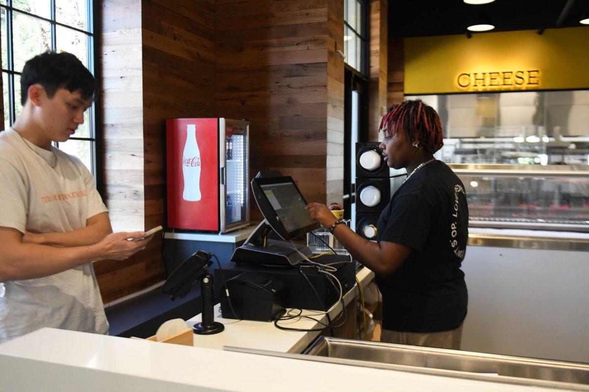 LSU psychology sophomore Shanice Snell rings up a customer at the new Dairy Store location Tuesday, Feb. 20, 2024, on S. Campus Dr. on LSU&#8217;s campus in Baton Rouge, La.