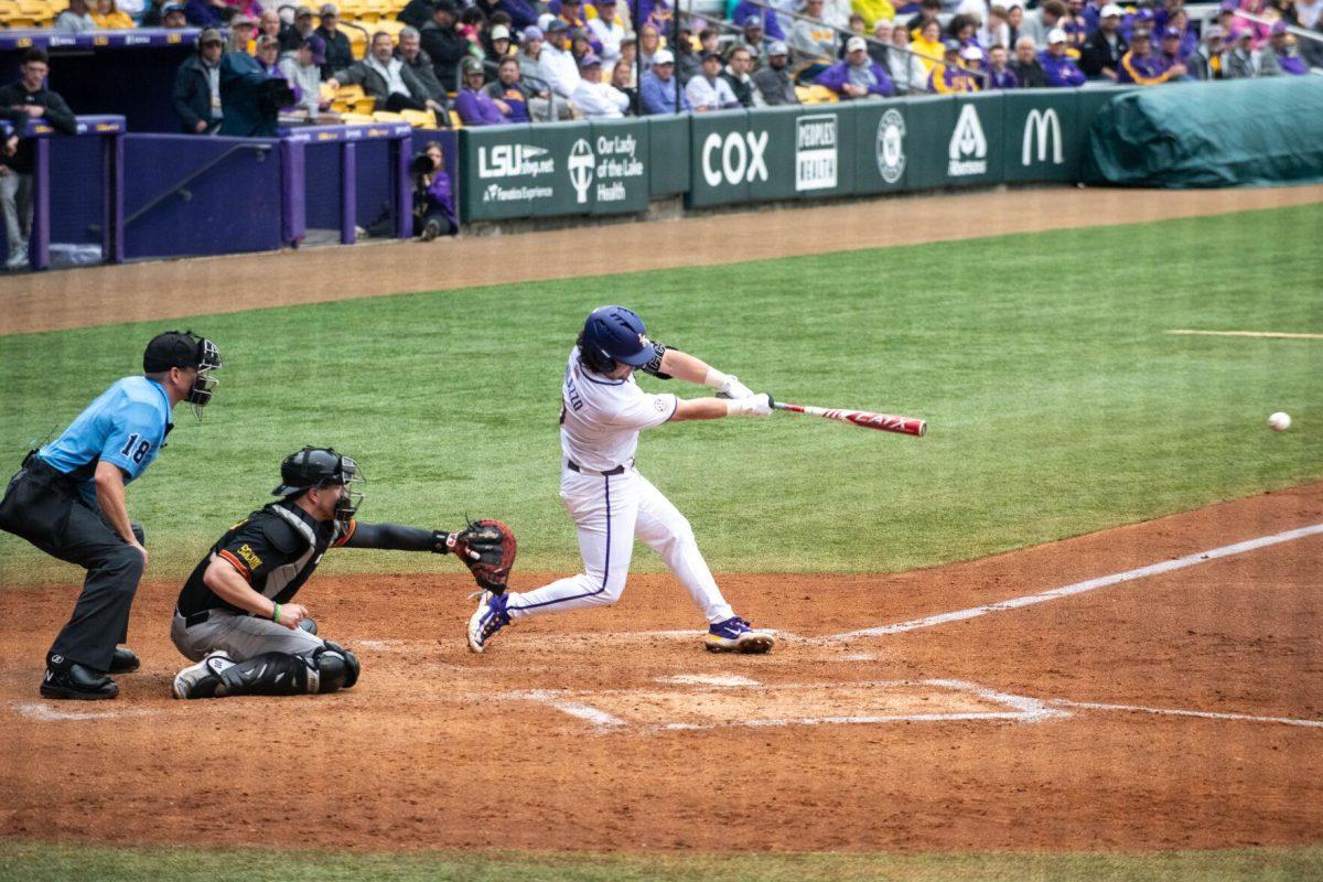 LSU baseball graduate student catcher Alex Milazzo (7) hits the ball right down the middle during LSU's 11-8 win against VMI on Friday, Feb. 16, 2024, at Alex Box Stadium in Baton Rouge, La.