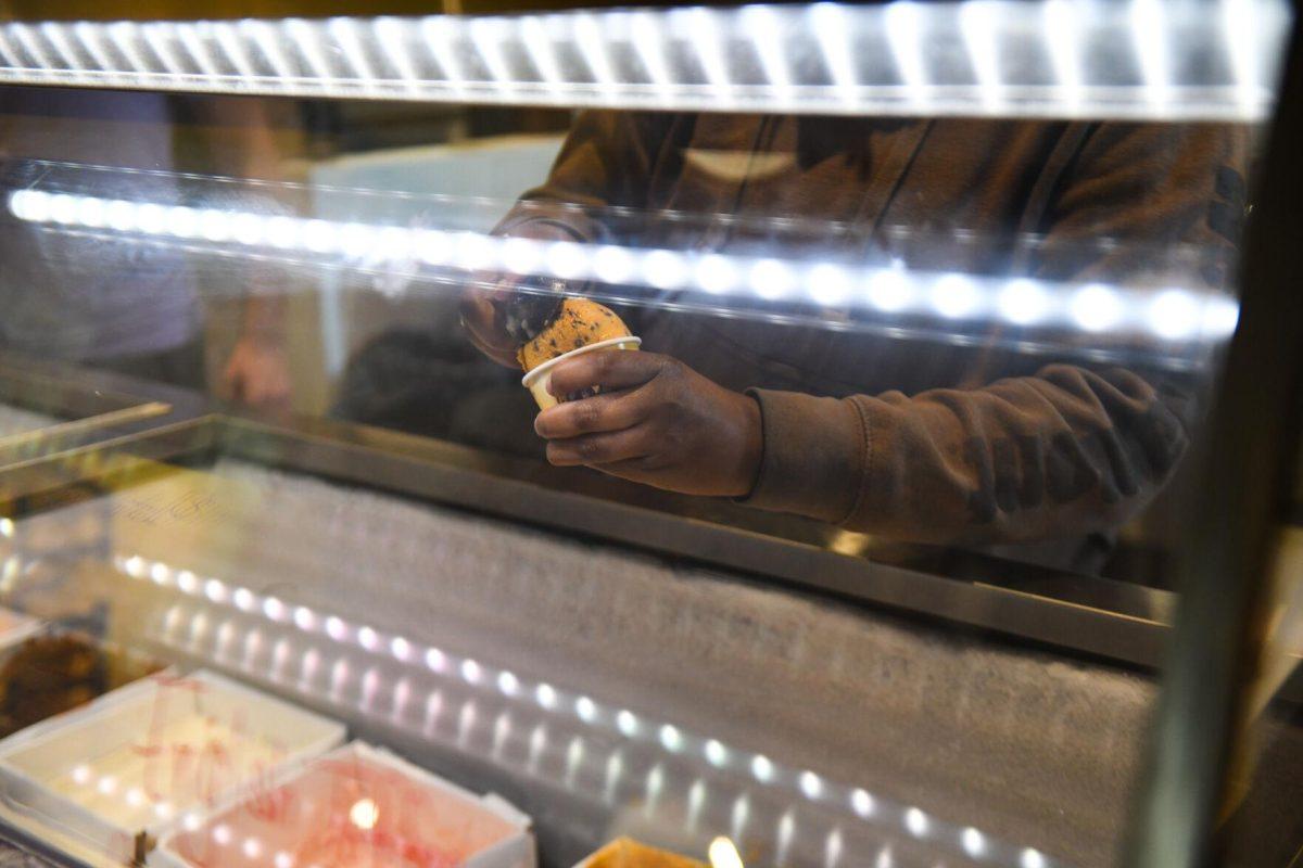 LSU psychology sophomore Shanice Snell scoops ice cream at the new Dairy Store location Tuesday, Feb. 20, 2024, on S. Campus Dr. on LSU&#8217;s campus in Baton Rouge, La.