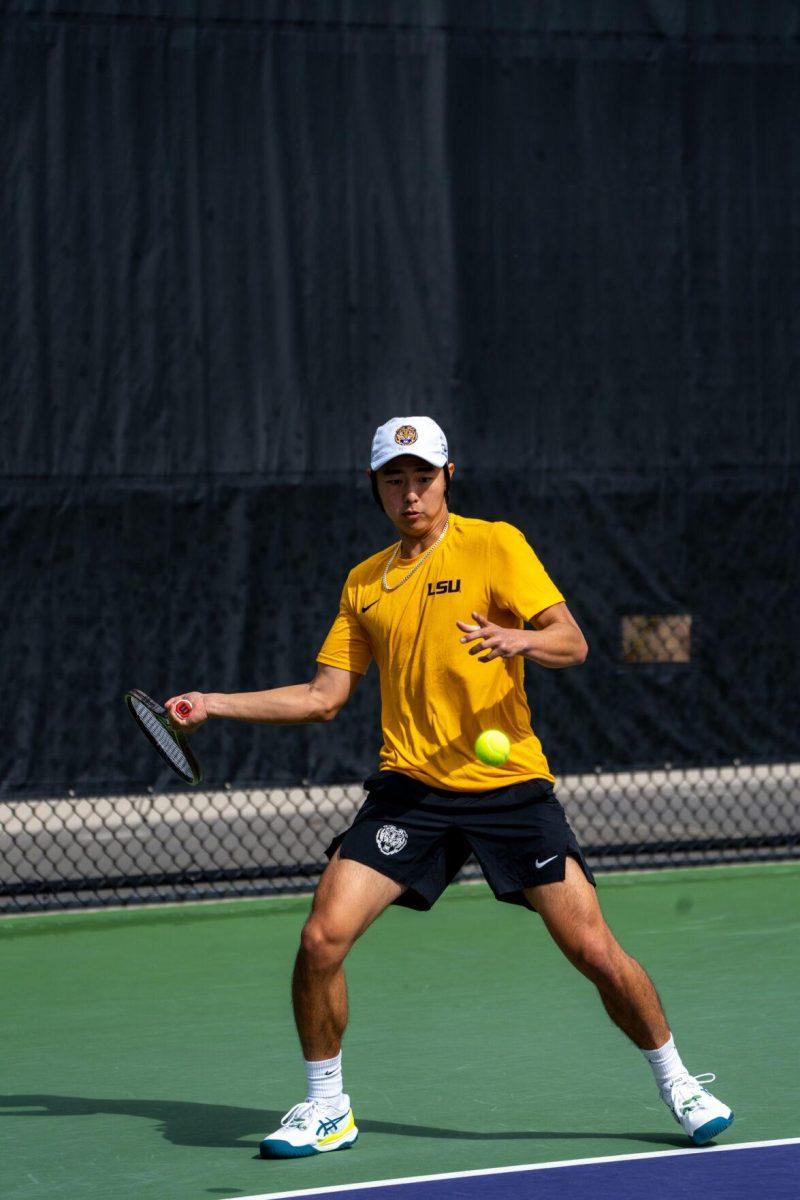 LSU men's tennis senior Chen Dong hits a forehand during his 5-7, 6-3, 6-2 singles win against Rice on Sunday, Feb. 4, 2023 at the LSU Tennis Complex on Gourrier Avenue in Baton Rouge, La.