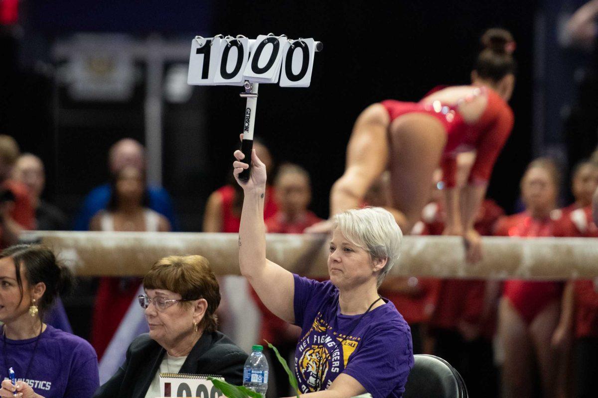 A woman holds up a 10 Friday, Feb. 2, 2024, during LSU&#8217;s 198.475-196.200 win against Arkansas at the Pete Maravich Assembly Center in Baton Rouge, La.