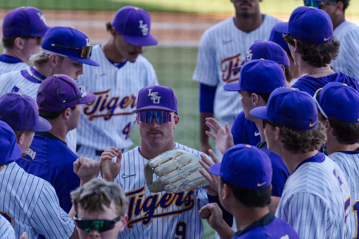 LSU baseball senior outfielder Mac Bingham (9) high fives teammates Friday, Feb. 23, 2024, during LSU&#8217;s 5-2 loss against Stony Brook at Alex Box Stadium in Baton Rouge, La.