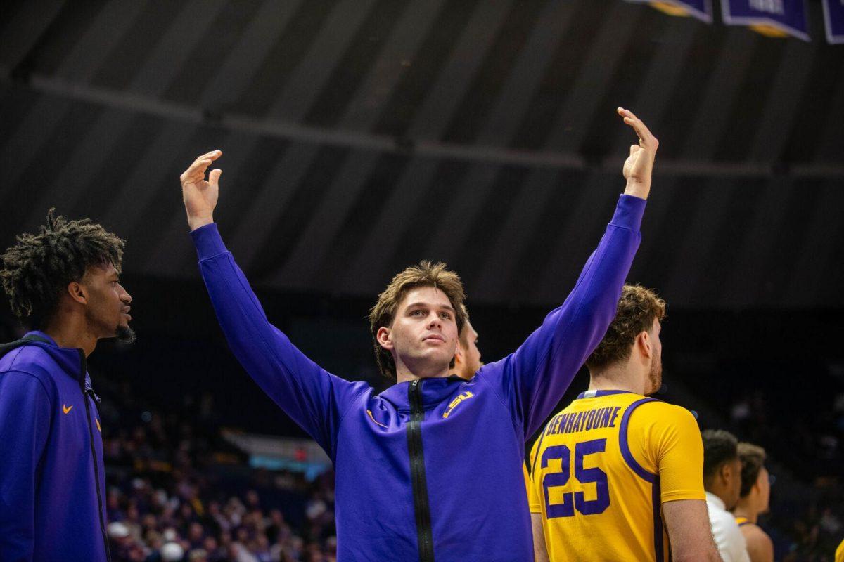 LSU men's basketball redshirt junior guard Trace Young (14) signals for the crowd to cheer louder on Saturday, Feb. 3, 2024, during LSU's 94-74 win against Arkansas in the Pete Maravich Assembly Center in Baton Rouge, La.