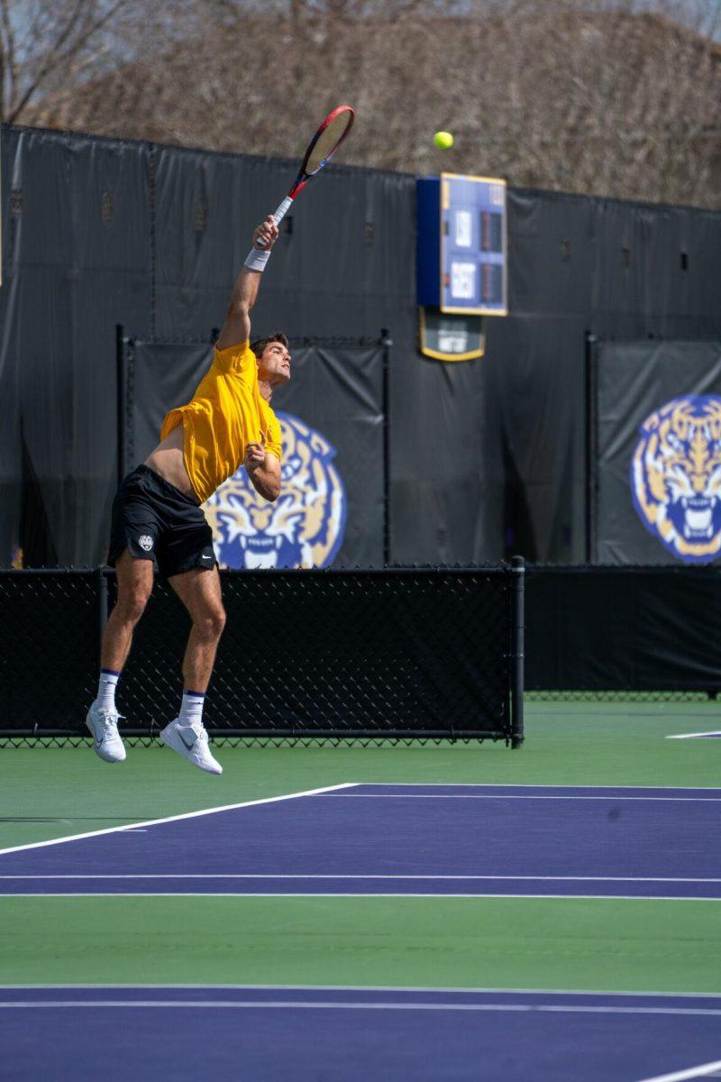 LSU men's tennis 5th-year senior Stefan Latinovic hits a serve during his 6-3, 7-6 singles win against Rice Sunday, Feb. 4, 2023 at the LSU Tennis Complex on Gourrier Avenue in Baton Rouge, La.