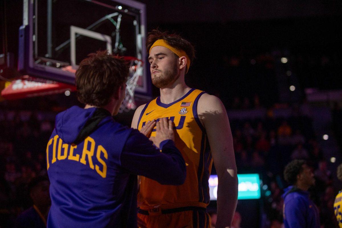 LSU men's basketball graduate student forward Will Baker (9) and redshirt junior guard Trace Young (14) perform their walkout handshake on Saturday, Feb. 3, 2024, before LSU's 94-74 win against Arkansas in the Pete Maravich Assembly Center in Baton Rouge, La.