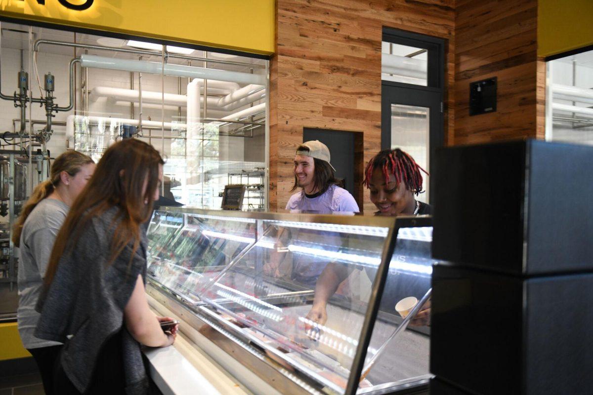 LSU sophomores Tyler Besse and Shanice Snell serve customers at the new Dairy Store location Tuesday, Feb. 20, 2024, on S. Campus Dr. on LSU&#8217;s campus in Baton Rouge, La.