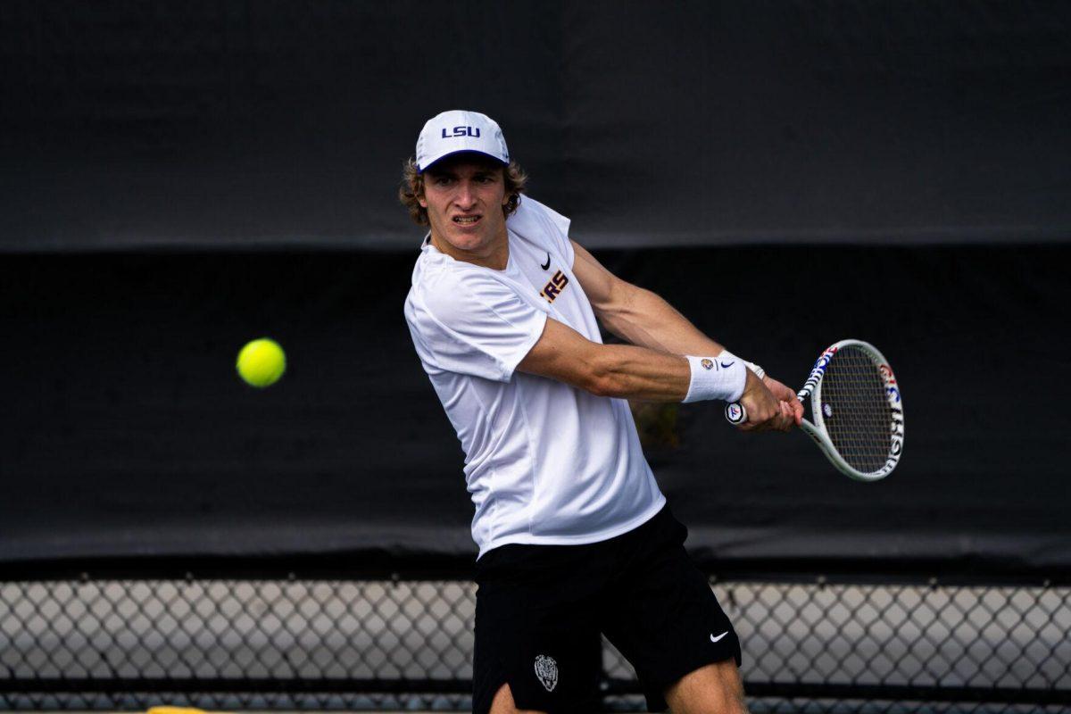 LSU men's tennis 5th-year senior George Stoupe hits a backhand during his 6-3, 3-6, 6-1 singles win against Rice Sunday, Feb. 4, 2023 at the LSU Tennis Complex on Gourrier Avenue in Baton Rouge, La.