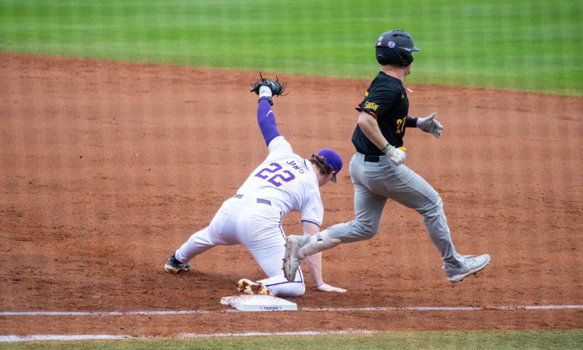 LSU baseball sophomore first basemen Jared Jones (22) catches the ball during LSU's 11-8 win against VMI on Friday, Feb. 16, 2024, at Alex Box Stadium in Baton Rouge, La.