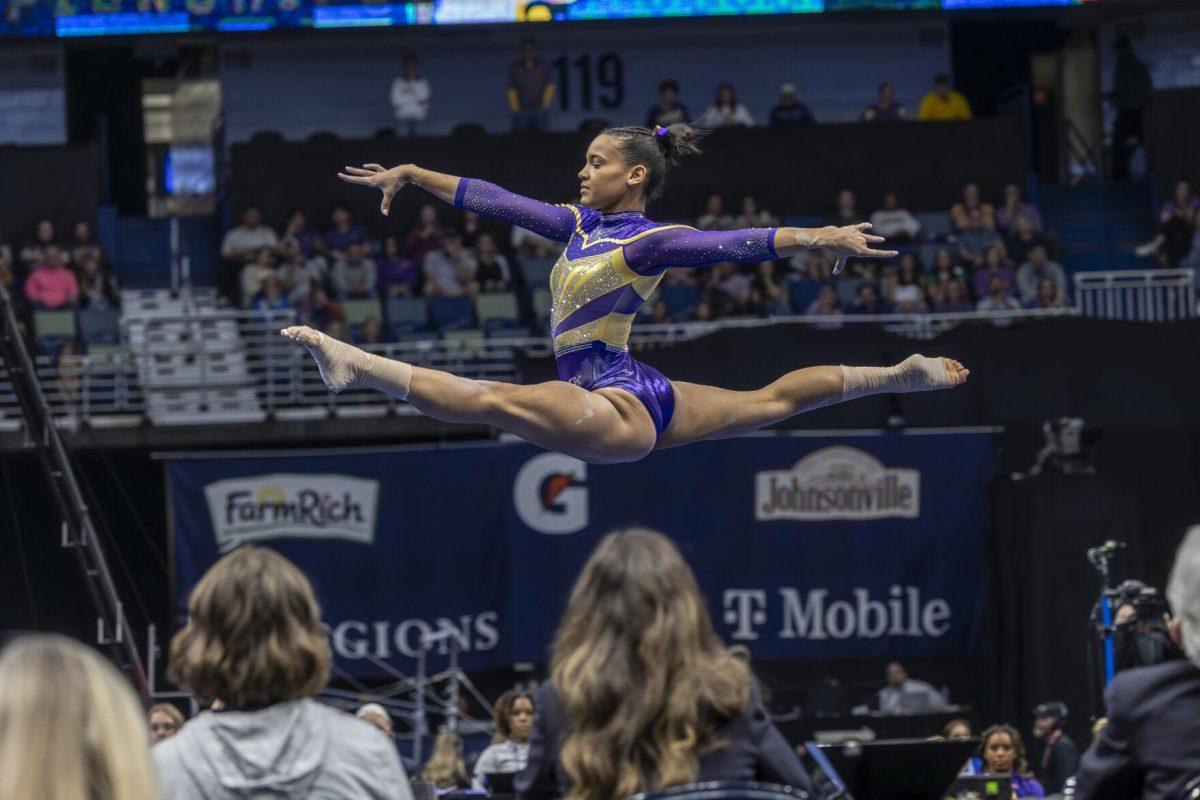 LSU gymnastics senior all-around graces through the air Saturday, March 23, 2024, during LSU's 198.075 victory in the 2024 SEC Gymnastics Championship in the Smoothie King Center in New Orleans, La.