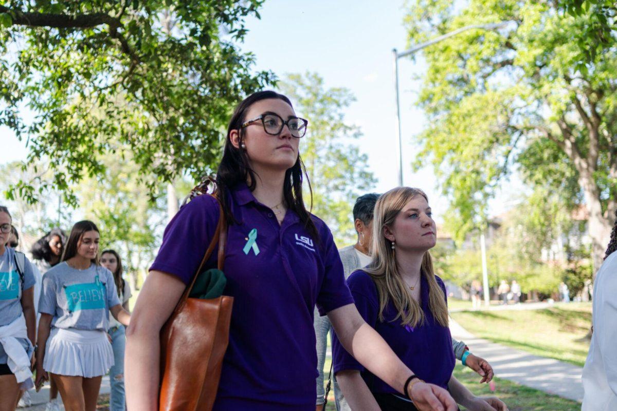 LSU student body vice president Gigi Powers (left) and president Anna Cate Strong (right) participate in the march Tuesday, March 26, 2024, at the Believe March on LSU's campus.