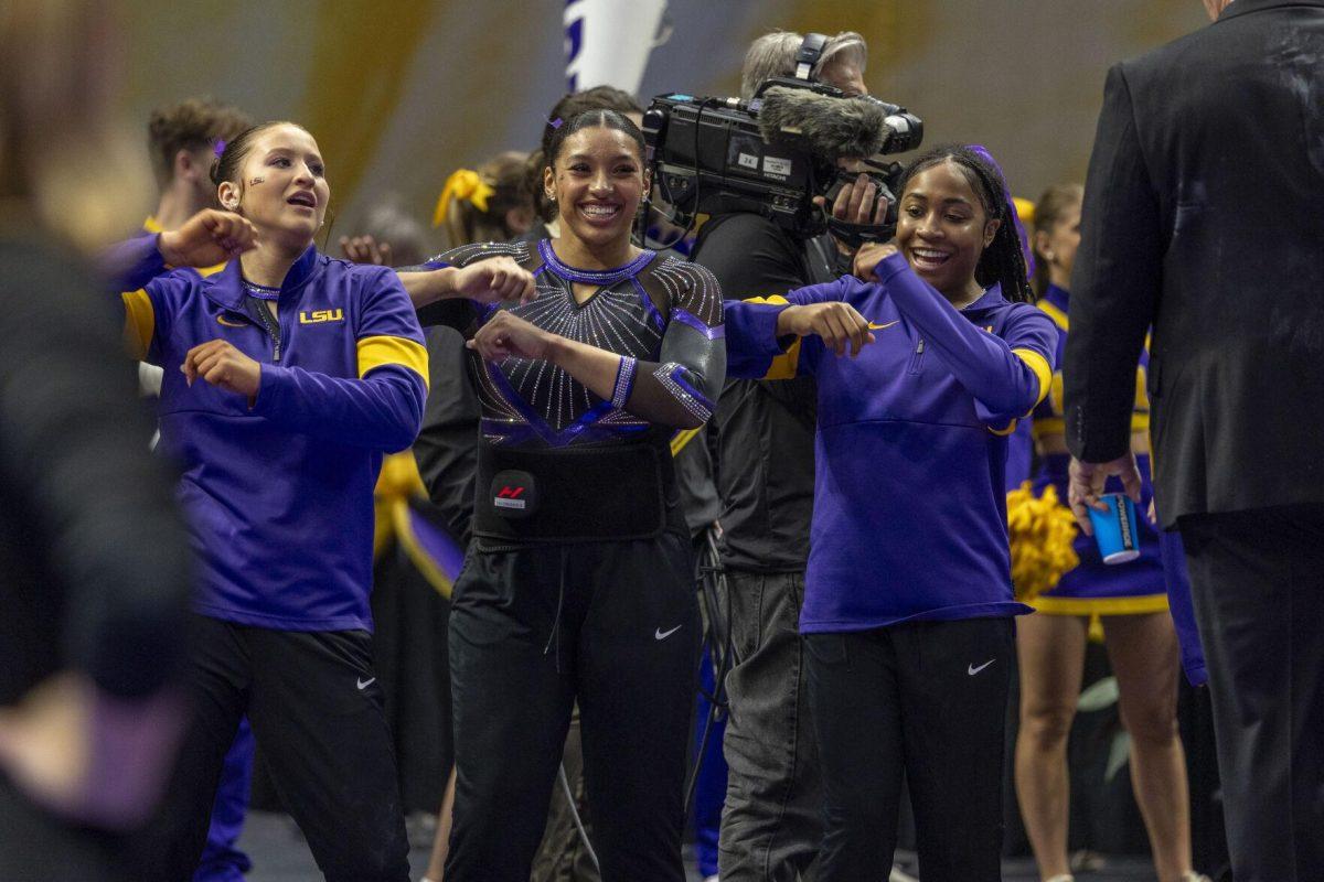 LSU gymnastics teammates dance to the music Friday, March 1, 2024, during LSU's 198.325-197.325 win over Alabama in the Pete Maravich Assembly Center.