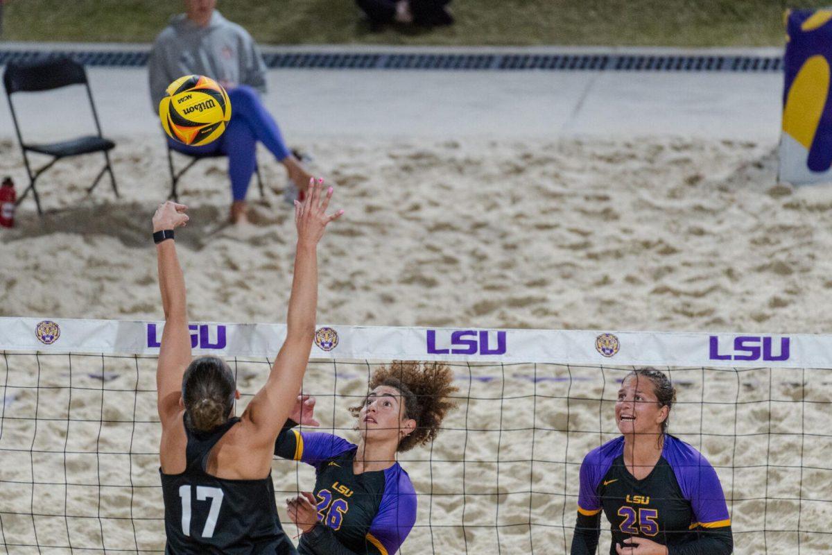 LSU beach volleyball freshman Yali Ashush (26) hits the ball through a defender's hands Saturday, March 2, 2024, during LSU&#8217;s 5-0 win against Nebraska at the LSU Beach Volleyball Stadium in Baton Rouge, La.