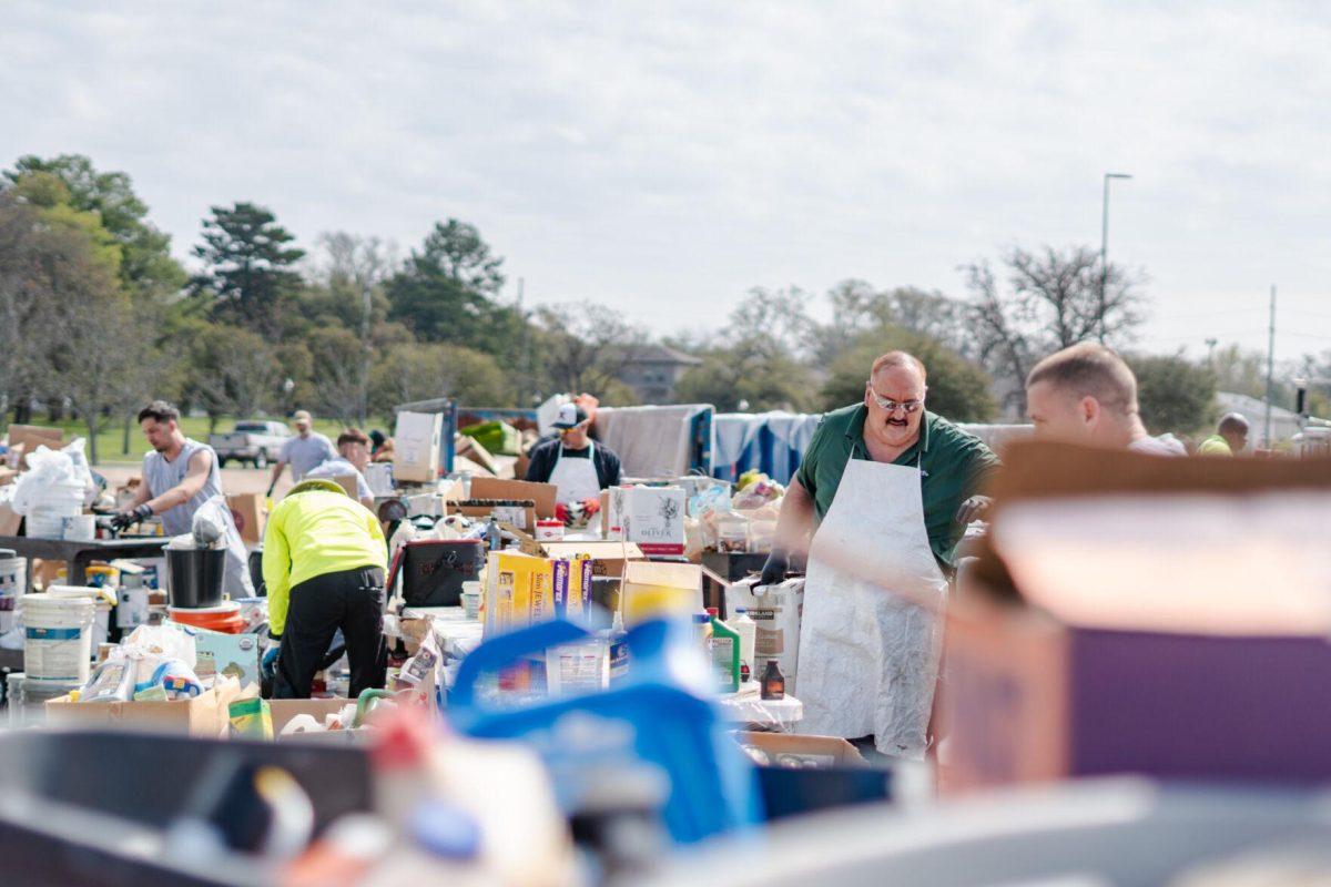 Workers sort and move various items Saturday, March 2, 2024, at the Household Hazardous Materials Collection Day on LSU's campus in Baton Rouge, La.