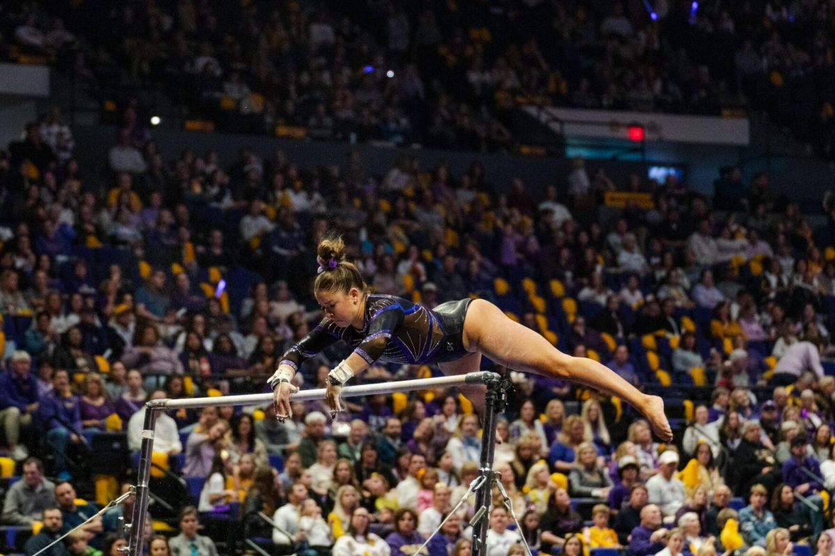 LSU gymnastics all-around sophomore Ashley Cowan regrips the bar Friday, March 1, 2024, during LSU&#8217;s 198.325-197.325 win against Alabama in the Pete Maravich Assembly Center in Baton Rouge, La.