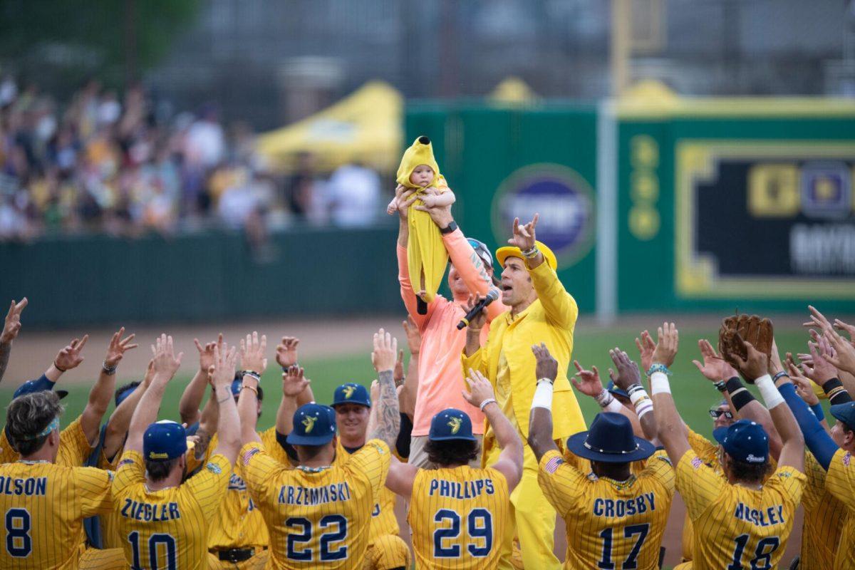 The Savannah Bananas worship a baby in a banana costume Thursday, March 14, 2024, before the Savannah Bananas 5-4 loss to the Party Animals during their world tour stop at Alex Box Stadium in Baton Rouge, La.