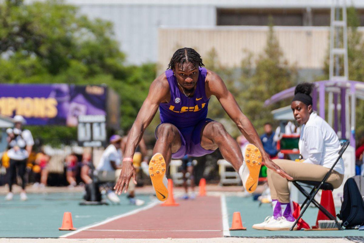 LSU track and field jumps senior Ji'eem Bullock flies through the air Saturday, March 23, 2024, during the Keyth Talley Invitational at the Bernie Moore Track Stadium in Baton Rouge, La.