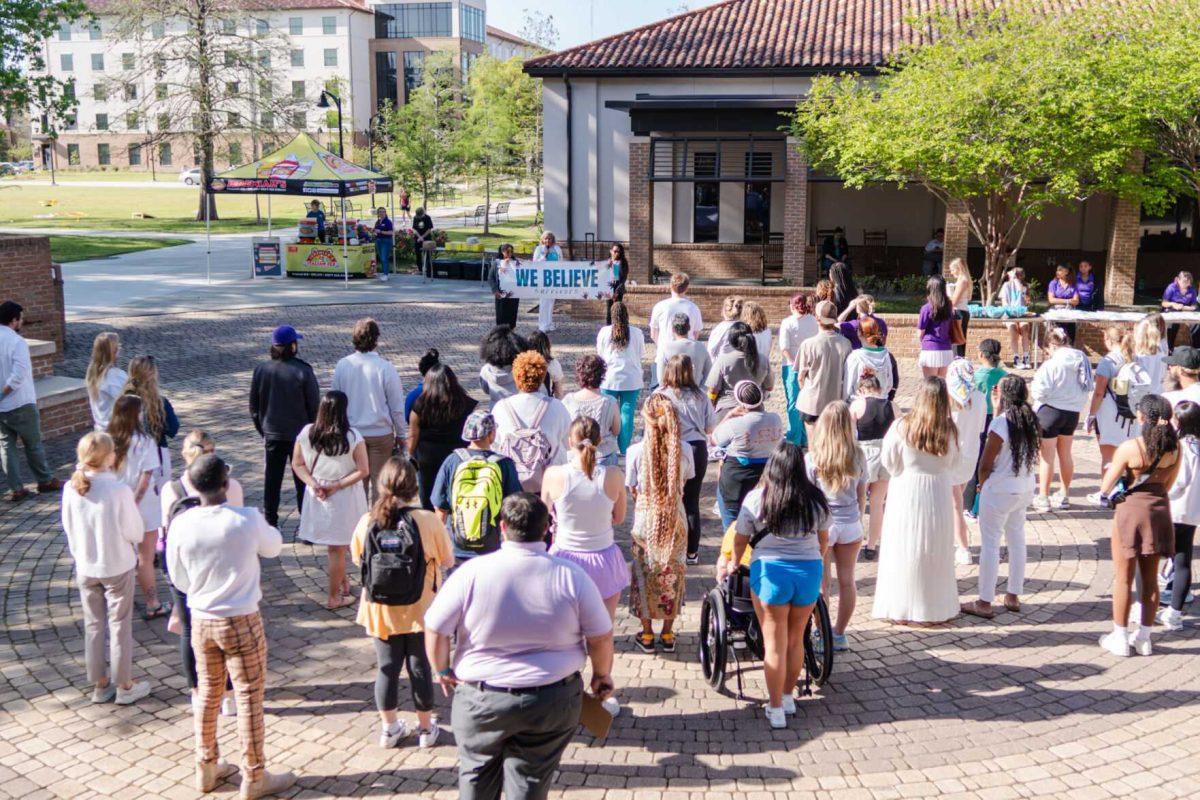 Attendees listen to Director of the Lighthouse Program Kreslyn Kelley-Ellis speak after the march Tuesday, March 26, 2024, at the Believe March on LSU's campus.