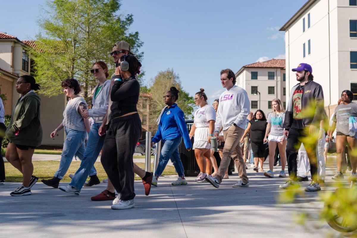 Attendees walk the route in silence Tuesday, March 26, 2024, at the Believe March on LSU's campus.