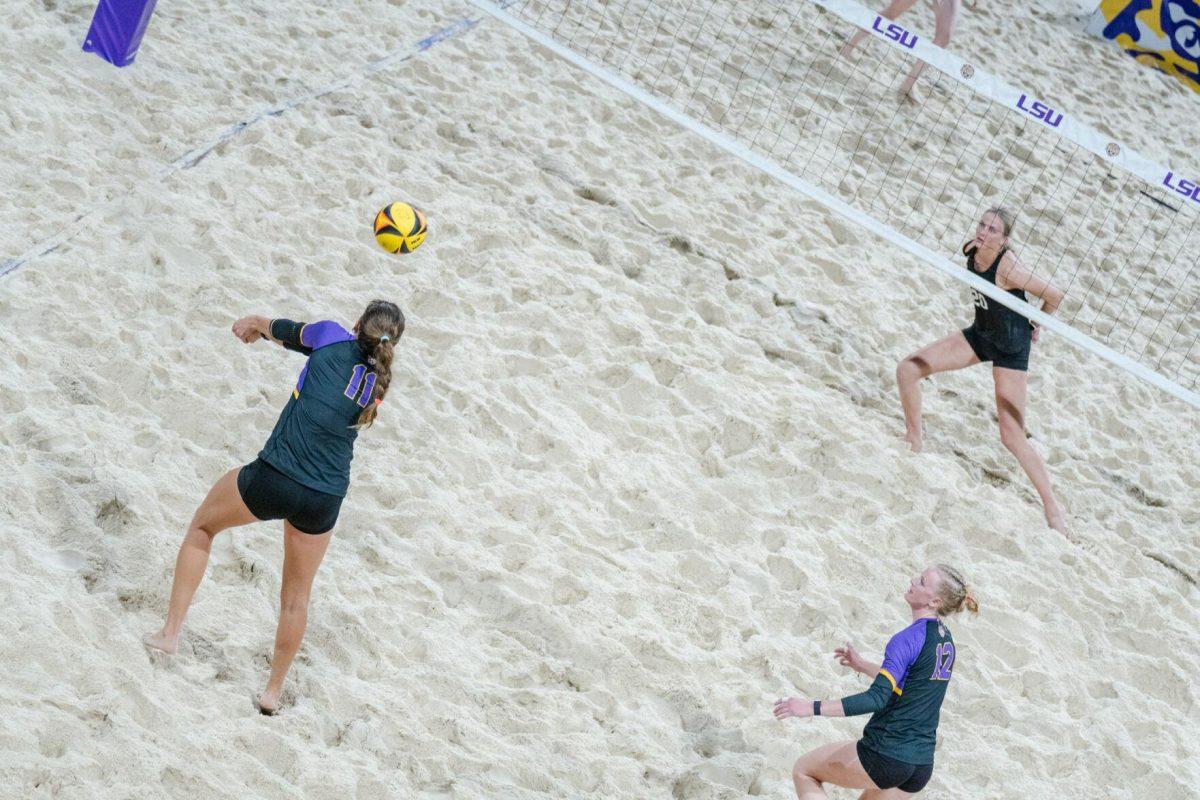 LSU beach volleyball graduate student Gabi Bailey (11) receives the serve Saturday, March 2, 2024, during LSU&#8217;s 5-0 win against Nebraska at the LSU Beach Volleyball Stadium in Baton Rouge, La.