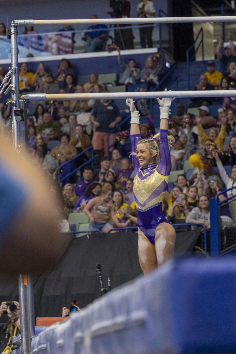 LSU gymnastics senior all-around Olivia Dunne celebrates her stick landing Saturday, March 23, 2024, during LSU's 198.075 victory in the 2024 SEC Gymnastics Championship in the Smoothie King Center in New Orleans, La.