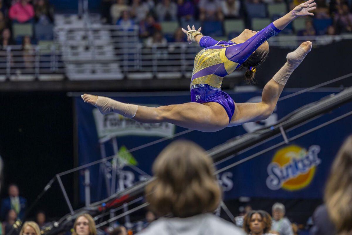 LSU gymnastics junior all-around Aleah Finnegan leaps through the air Saturday, March 23, 2024, during LSU's 198.075 victory in the 2024 SEC Gymnastics Championship in the Smoothie King Center in New Orleans, La.