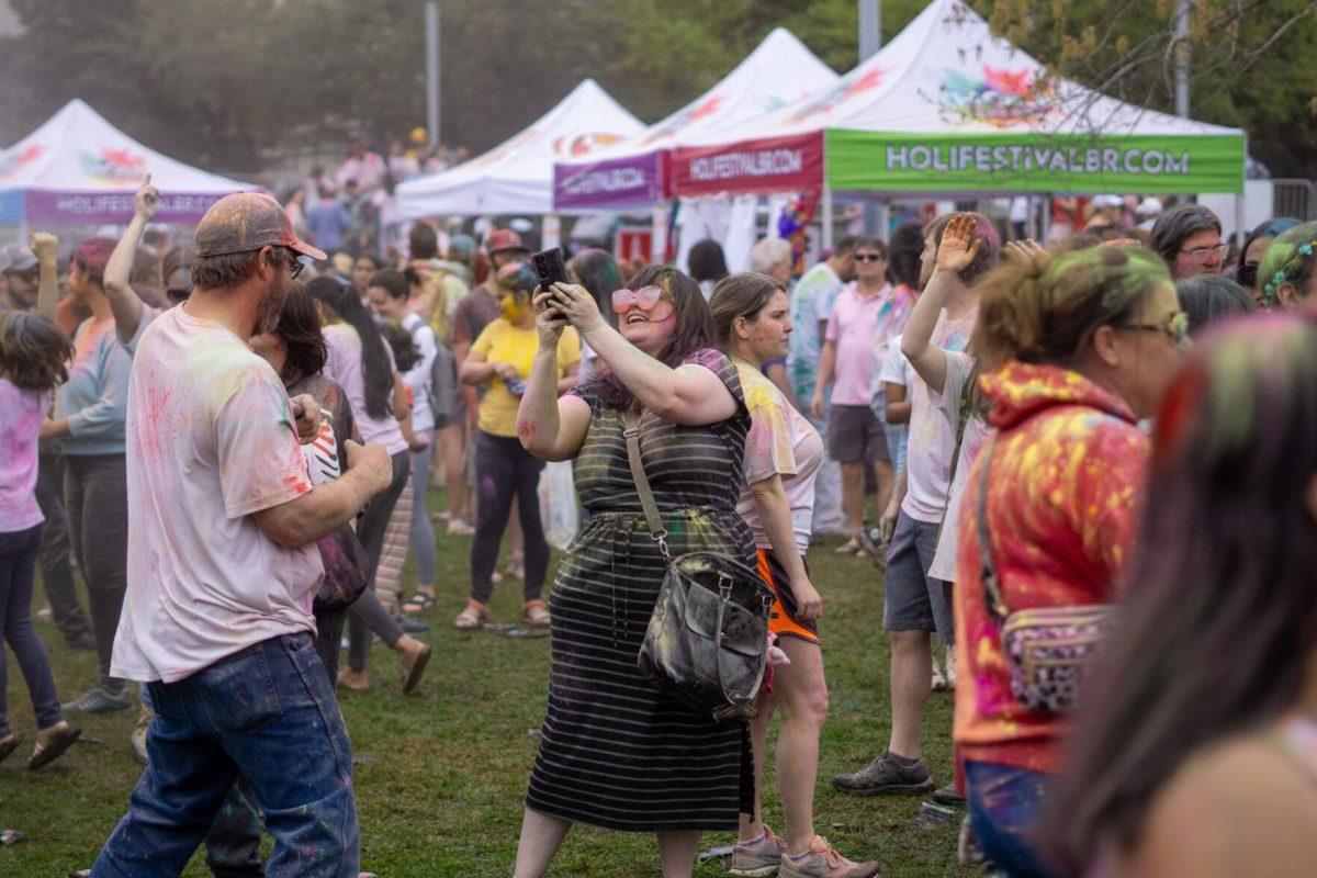 Holi festival participants throw powder Saturday, March 9, 2024, at the Holi Festival at Repentance Park in Baton Rouge La.