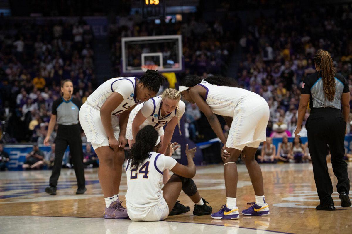 LSU women&#8217;s basketball players surround junior guard Aneesah Morrow (24) after a fall Sunday, March 24, 2024, during LSU&#8217;s 83-56 second-round NCAA tournament win against Middle Tennessee at the Pete Maravich Center in Baton Rouge, La.