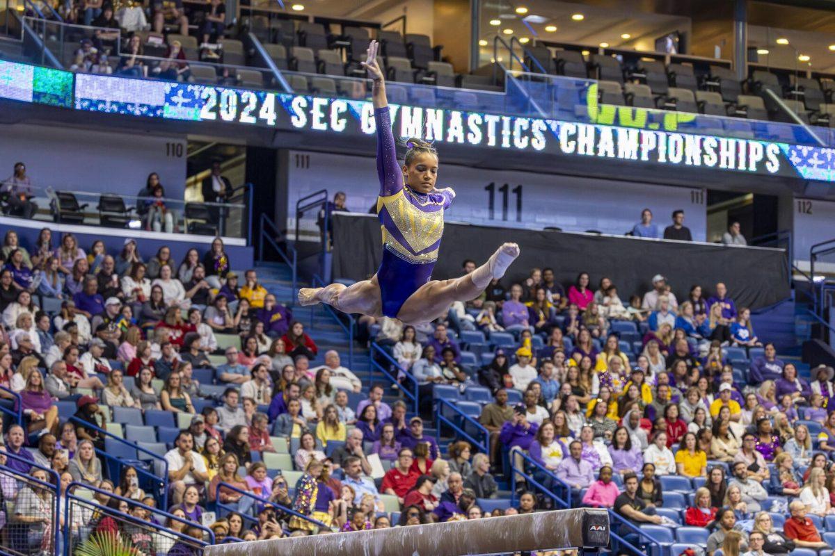 LSU gymnastics senior all-around Haleigh Bryant splits the air Saturday, March 23, 2024, during LSU's 198.075 victory in the 2024 SEC Gymnastics Championship in the Smoothie King Center in New Orleans, La.