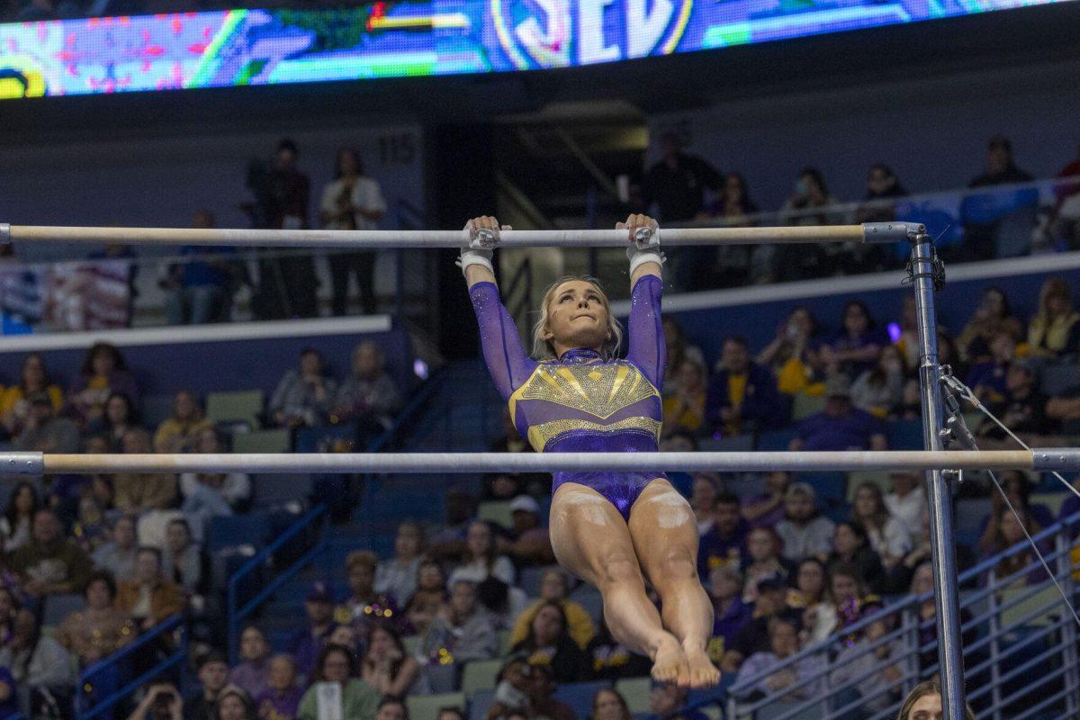 LSU gymnastics senior all-around Olivia Dunne swings between uneven bars Saturday, March 23, 2024, during LSU's 198.075 victory in the 2024 SEC Gymnastics Championship in the Smoothie King Center in New Orleans, La.