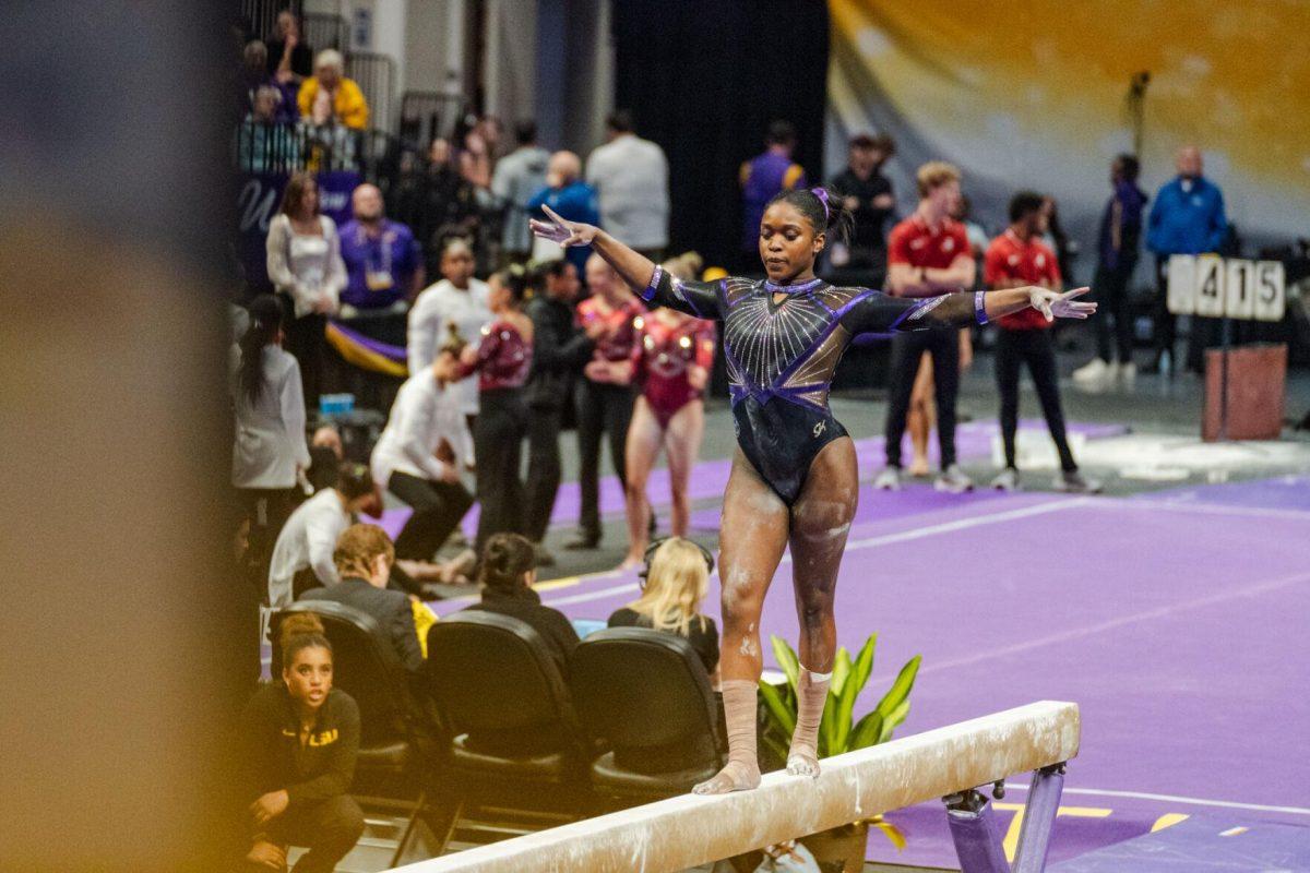 LSU gymnastics all-around graduate student Kiya Johnson poses on the beam Friday, March 1, 2024, during LSU&#8217;s 198.325-197.325 win against Alabama in the Pete Maravich Assembly Center in Baton Rouge, La.