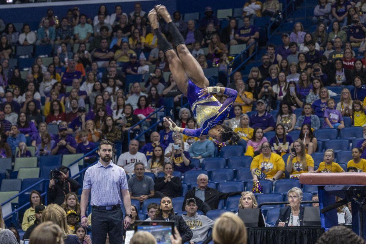 LSU gymnastics freshman all-around Amari Drayton spins through the air Saturday, March 23, 2024, during LSU's 198.075 victory in the 2024 SEC Gymnastics Championship in the Smoothie King Center in New Orleans, La.