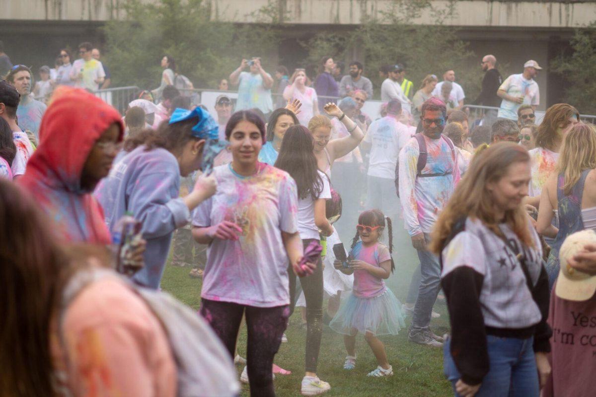 Holi festival participants throw powder Saturday, March 9, 2024, at the Holi Festival at Repentance Park in Baton Rouge La.