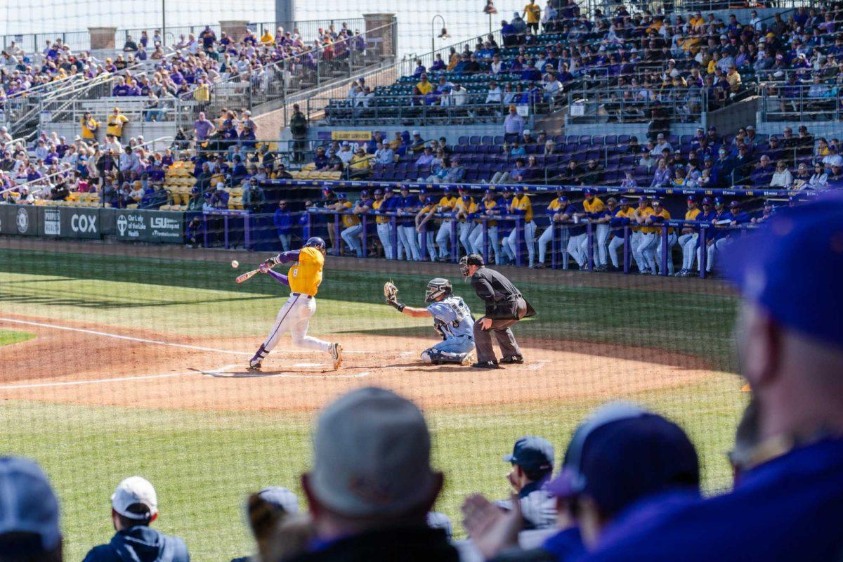 LSU baseball graduate student catcher Hayden Travinski (8) hits the ball Sunday, March 10, 2024, during LSU's 2-1 loss to Xavier in Alex Box Stadium in Baton Rouge, La.