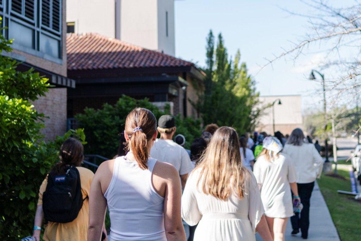 Attendees walk the route in silence Tuesday, March 26, 2024, at the Believe March on LSU's campus.