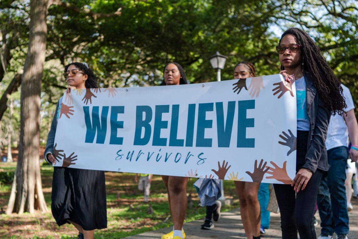 Attendees walk the route in silence Tuesday, March 26, 2024, at the Believe March on LSU's campus.