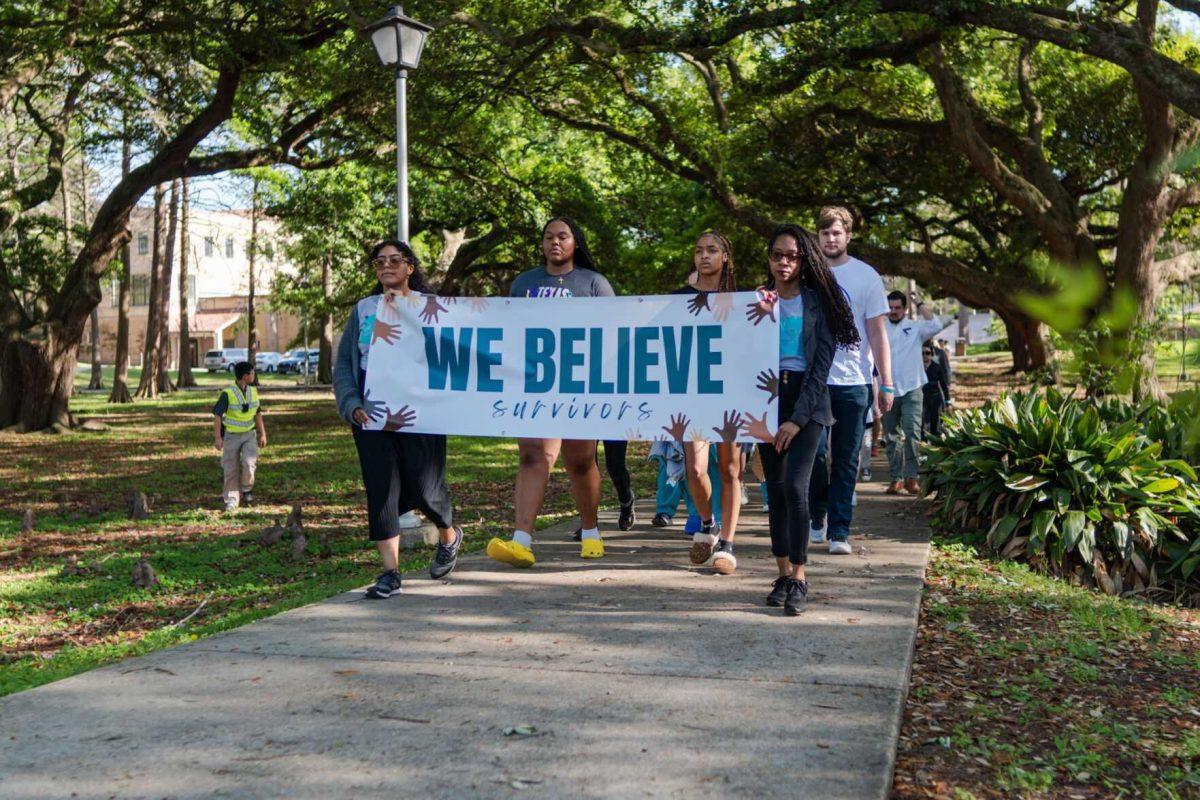 Attendees walk the route in silence Tuesday, March 26, 2024, at the Believe March on LSU's campus.