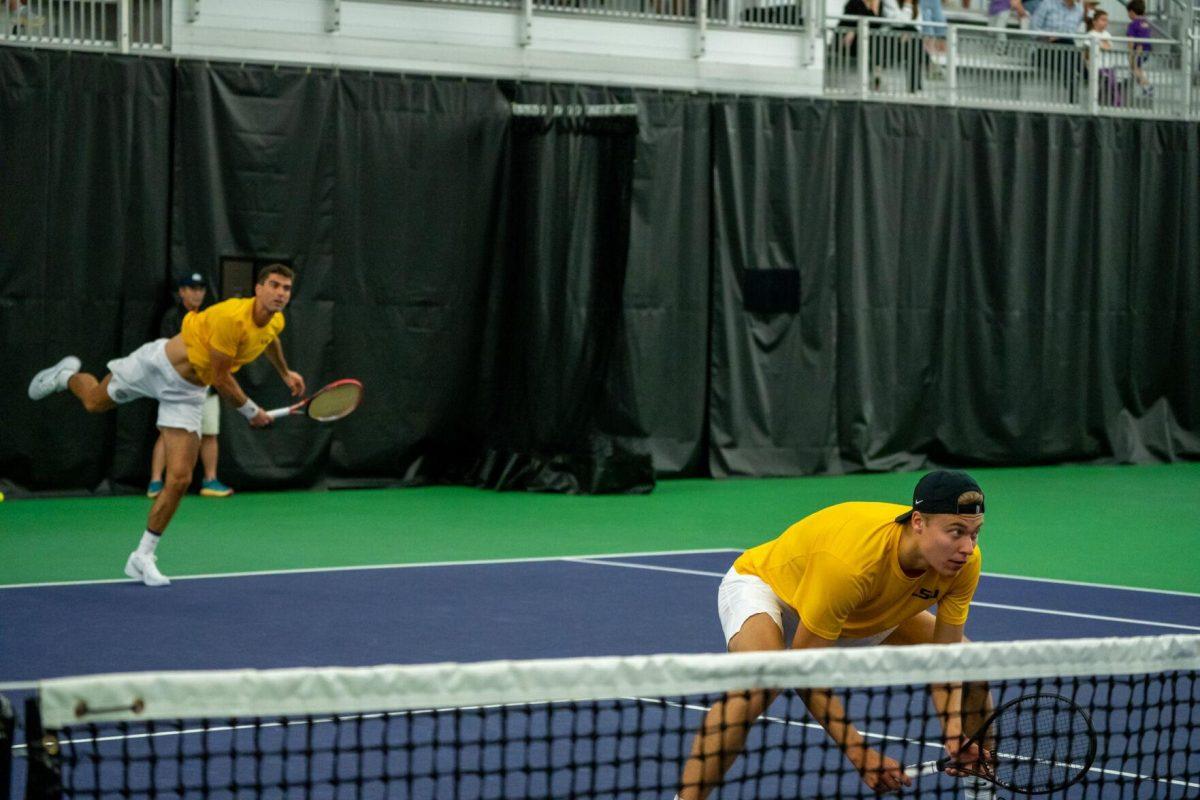 LSU men's tennis freshman Aleksi Lofman readys at the net with 5th-year senior Stefan Latinovic serving behind during their 5-7 doubles match against Ole Miss Friday, March 8, 2024, at the LSU tennis complex on Gourrier Avenue in Baton Rouge, La.