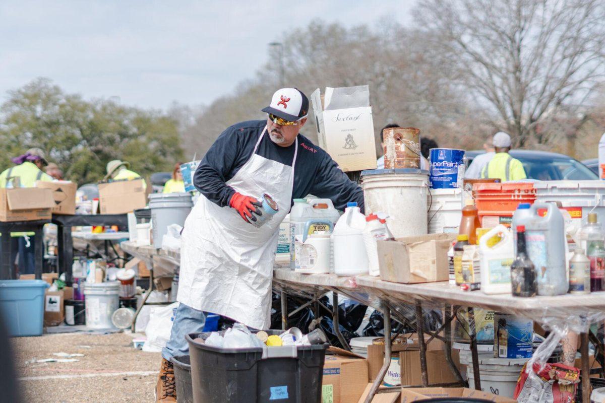 A worker sorts various items Saturday, March 2, 2024, at the Household Hazardous Materials Collection Day on LSU's campus in Baton Rouge, La.