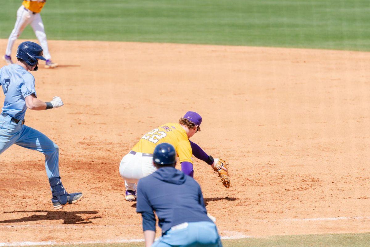 LSU baseball sophomore first baseman Jared Jones (22) attempts to catch the throw Sunday, March 10, 2024, during LSU's 2-1 loss to Xavier in Alex Box Stadium in Baton Rouge, La.