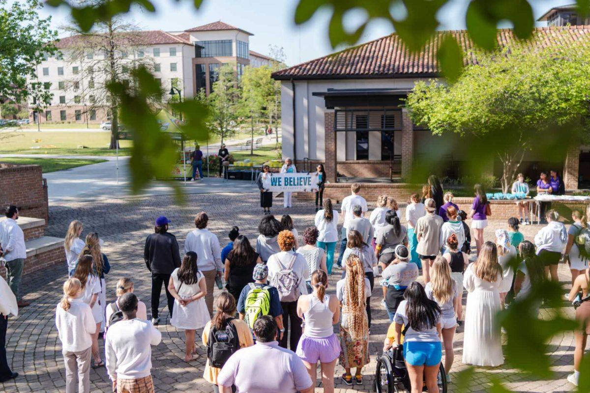 Attendees listen to Director of the Lighthouse Program Kreslyn Kelley-Ellis speak after the march Tuesday, March 26, 2024, at the Believe March on LSU's campus.